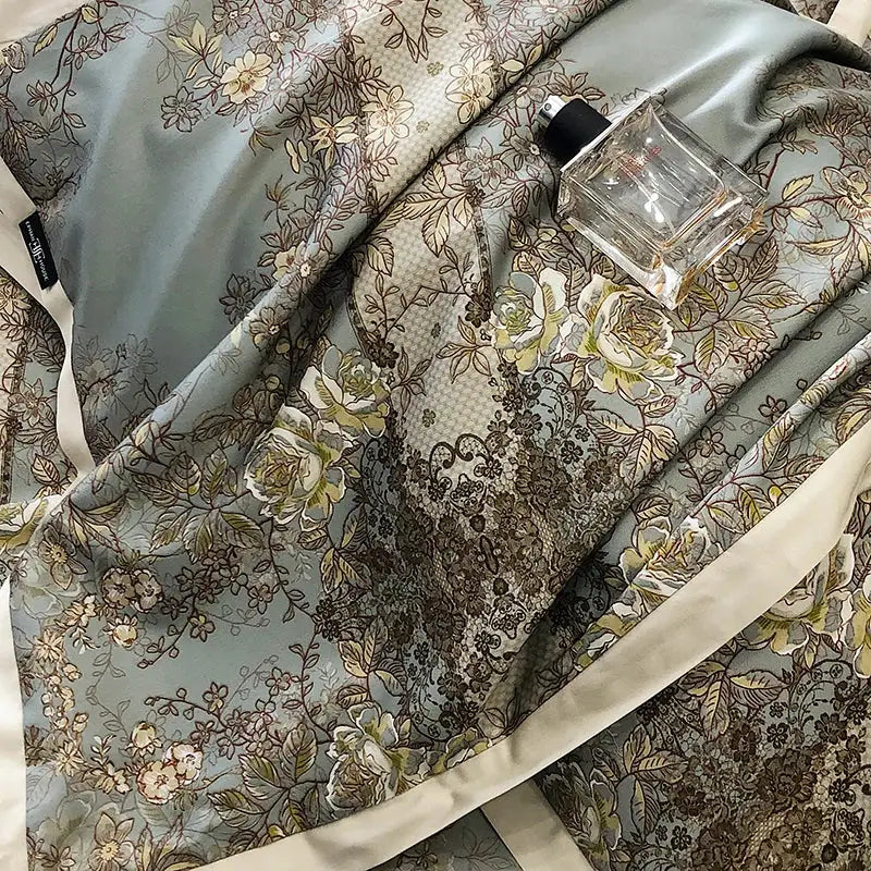 Elegant teal and gold floral luxury bedding set featuring a delicate light blue satin scarf with intricate lace patterns