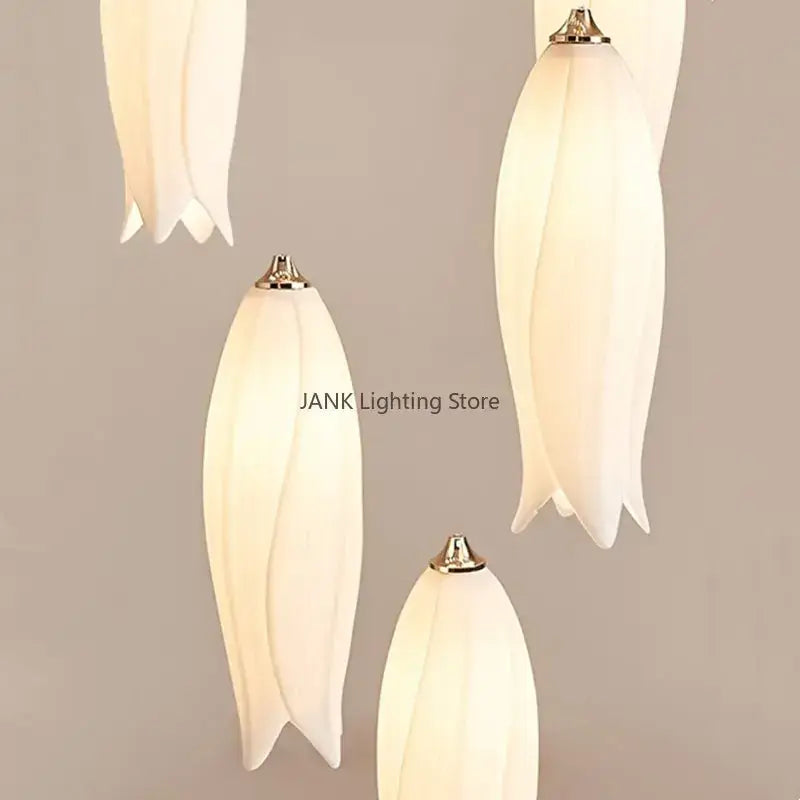 Elegant tulip staircase chandelier with white ceramic tulip-shaped pendant lights and gold-toned metal tops, decorbites elegant tulip design