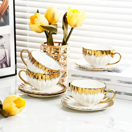 Elegant white and golden ceramic tea cup set with gold leaf detailing and matching saucers for dining room decorbites golden ceramic