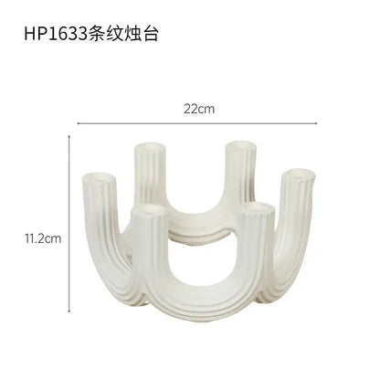 Elegant white ceramic candlestick holder with vertical ribbed texture and curved u-shaped design for dining room decorbites decor