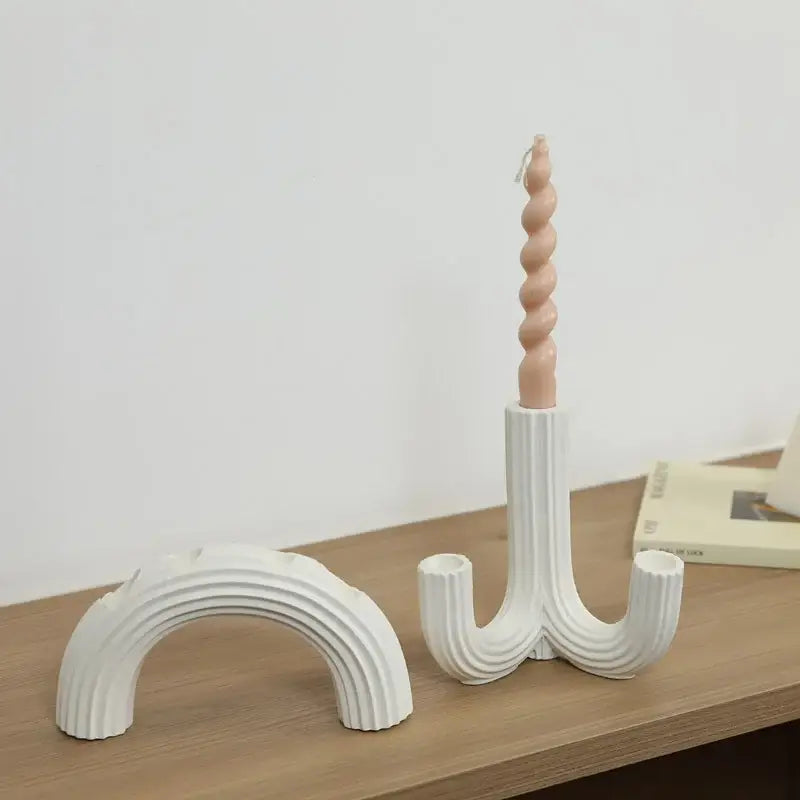 Elegant white ceramic candlestick holder with spiral design holding a peach twisted candle for dining room decorbites decor