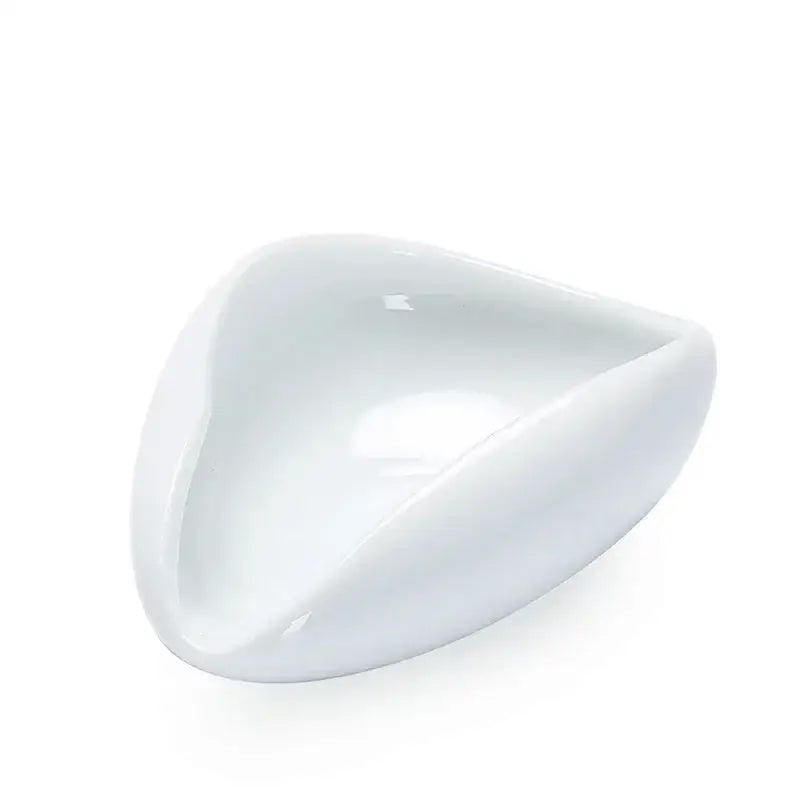 A sleek glossy white ceramic dose tray with a modern triangular design for decorbites ceramic white tea spoon set