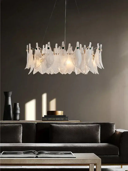 A modern decorbites cloud mist glass chandelier with translucent white feather-like elements and subtle green accents for bedroom decor