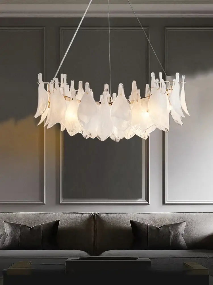 Elegant white feather cloud mist glass chandelier with modern leaf-like design hanging above sofa decorbites cloud mist