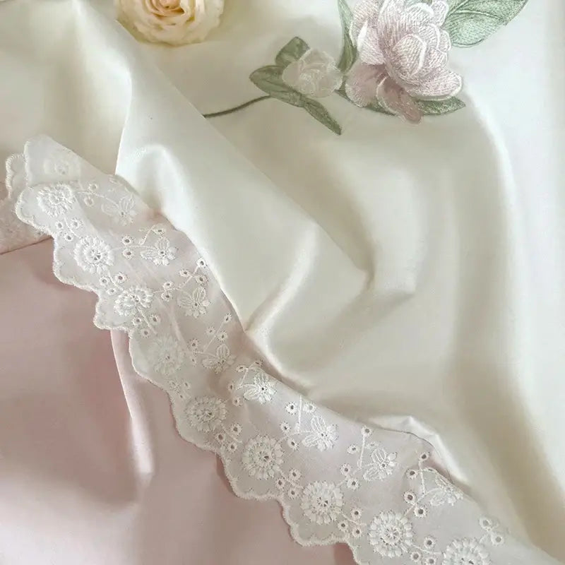 Elegant white flowers embroidery lace bedding set featuring delicate floral patterns and scalloped edges on satin fabric