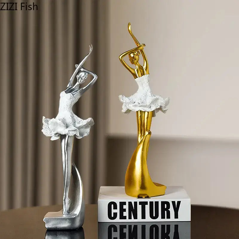 Two elegant silver and gold ballet dancer resin sculptures with white tutu skirts for bedroom decor or desk display