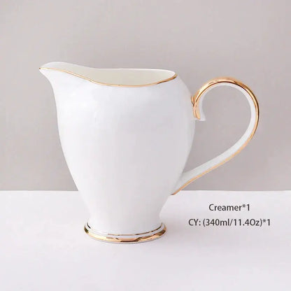 White ceramic creamer with gold trim part of elegant white and gold bone china coffee set for dining room use
