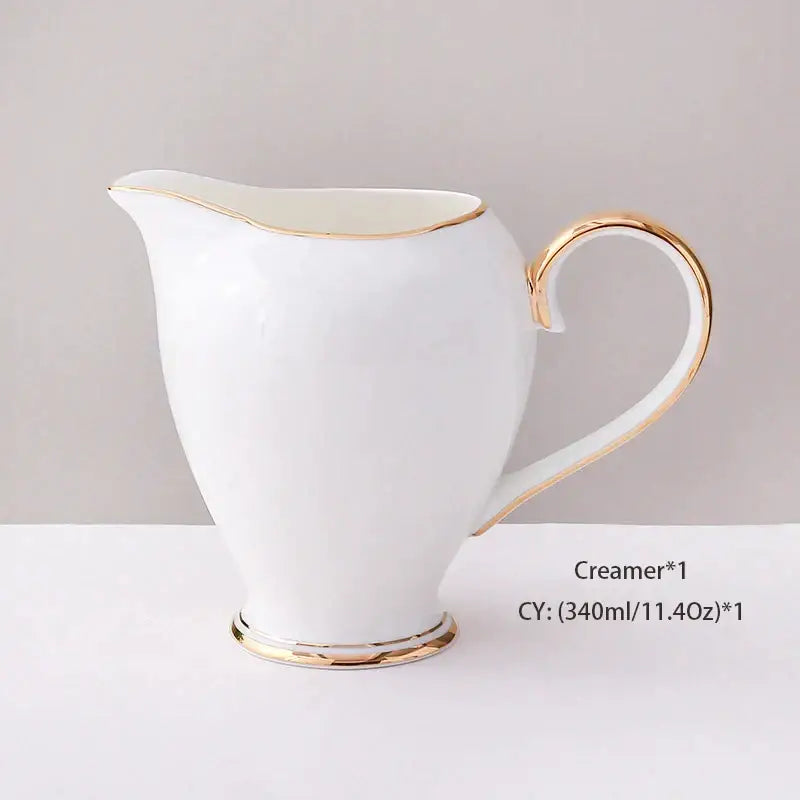 White ceramic creamer with gold trim part of elegant white and gold bone china coffee set for dining room use