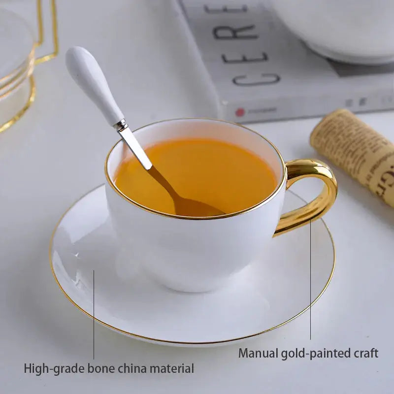 Elegant white and gold bone china tea set featuring a teacup with gold rim and handle paired with matching saucer decorbites elegant bone