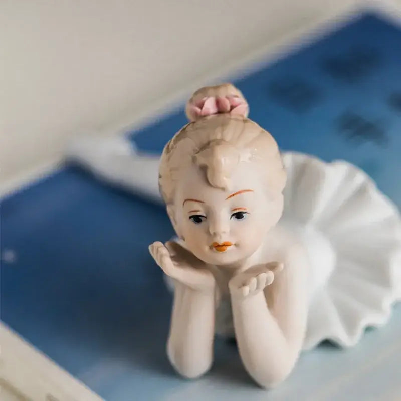 Elegant white porcelain ballet girl figurine with soft pink bun and white tutu for bedroom decor