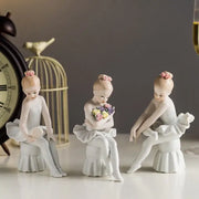 Elegant white porcelain ballet girl figurine set featuring three delicate ballet girl figurines with pink hair buns