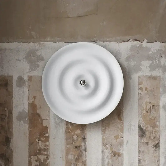 Elegant white ripple led wall sconce with concentric design and central metallic accent for bedroom decorbites elegant led light