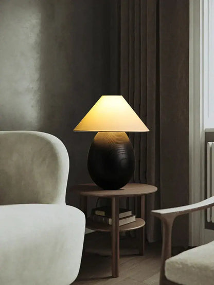 Warm-toned table lamp from decorbites elegant wood set with textured black ceramic base and beige fabric shade for bedroom decor