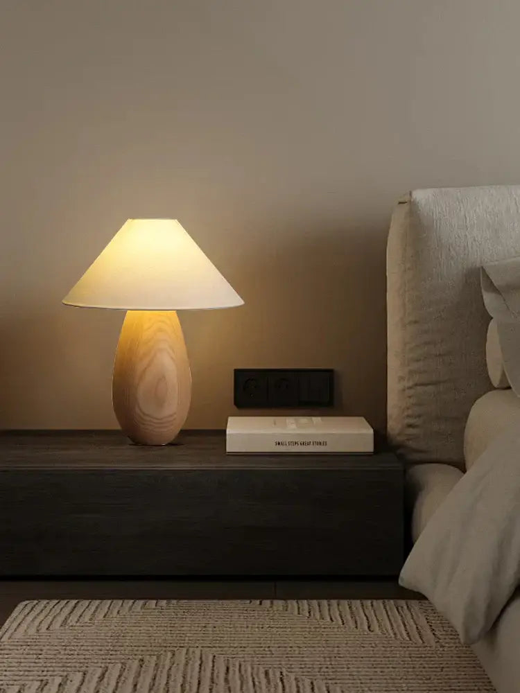 Elegant wood table lamp by decorbites with a warm-toned wooden base and cream fabric shade for bedroom decor