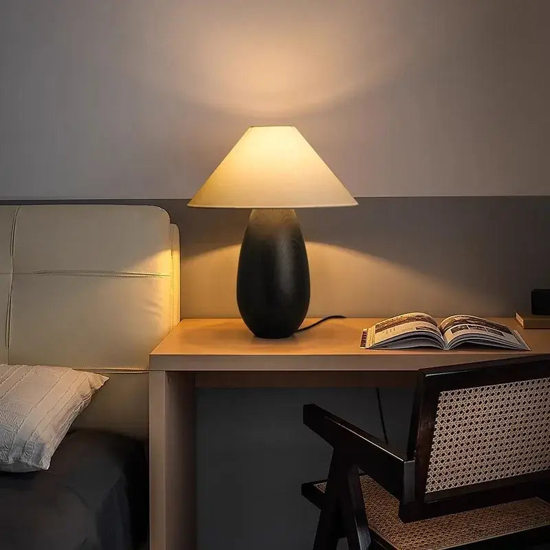 Warm-toned decorbites elegant wood table lamp with matte black base and beige fabric shade for bedroom decor
