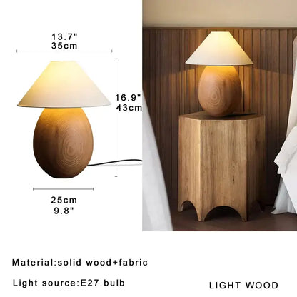 A warm-toned elegant wood table lamp with a smooth rounded base and cream fabric shade for bedroom decorbites elegant wood
