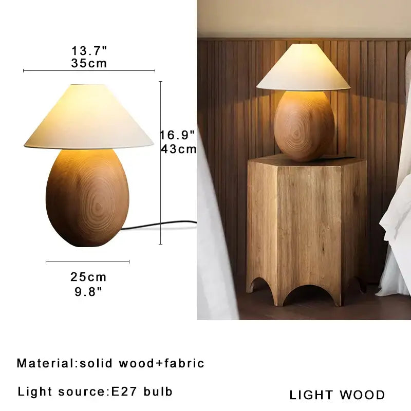 A warm-toned elegant wood table lamp with a smooth rounded base and cream fabric shade for bedroom decorbites elegant wood