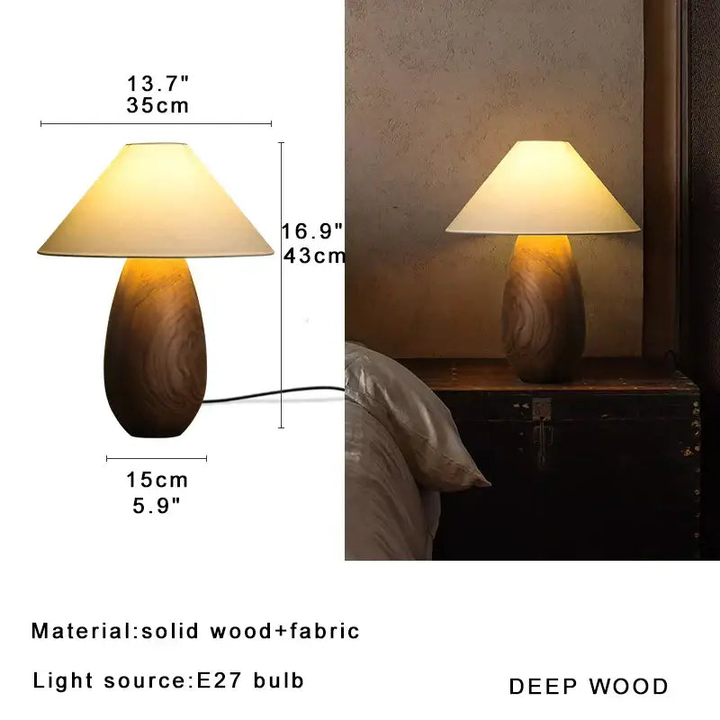 Elegant wood table lamp with warm-toned teardrop wooden base and cream fabric shade for bedroom decor by decorbites
