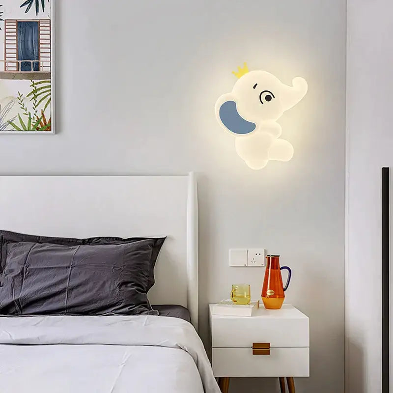 Cute white elephant cartoon wall light with blue ear and yellow crown designed for baby room decor