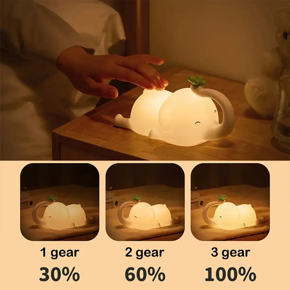 A soft white decorbites elephant silicone night light with a green clover leaf and three brightness settings for bedroom decor