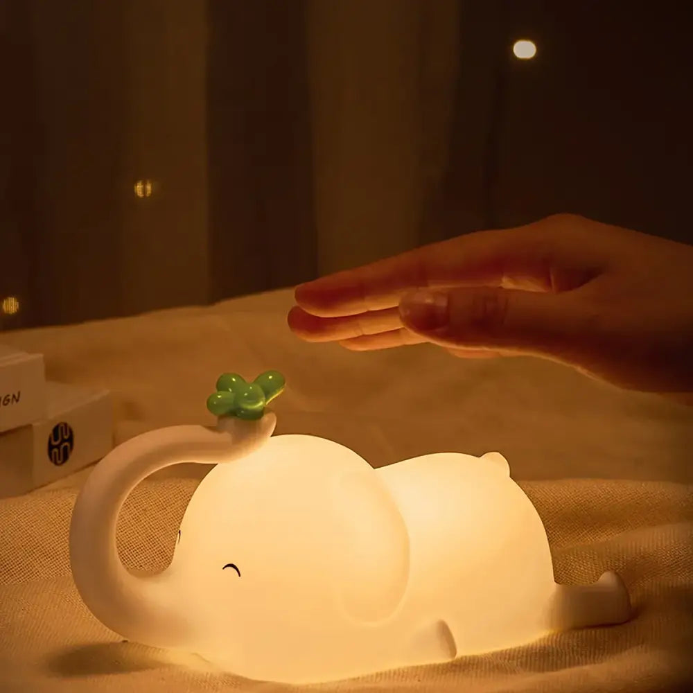 Soft white elephant silicone night light with a green clover glowing warmly for bedroom decorbites elephant silicone decor