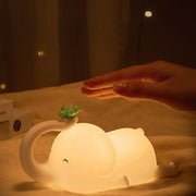 Soft white elephant silicone night light with a green clover glowing warmly for bedroom decorbites elephant silicone decor