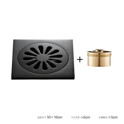 Black brass square floor drain with embossed floral sunburst pattern and gold cylindrical overflow cup for shower room by decorbites