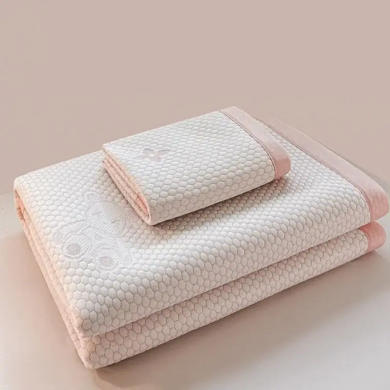 Soft off-white quilted cooling feel mat set with honeycomb texture and pink piping for bedroom mattress use