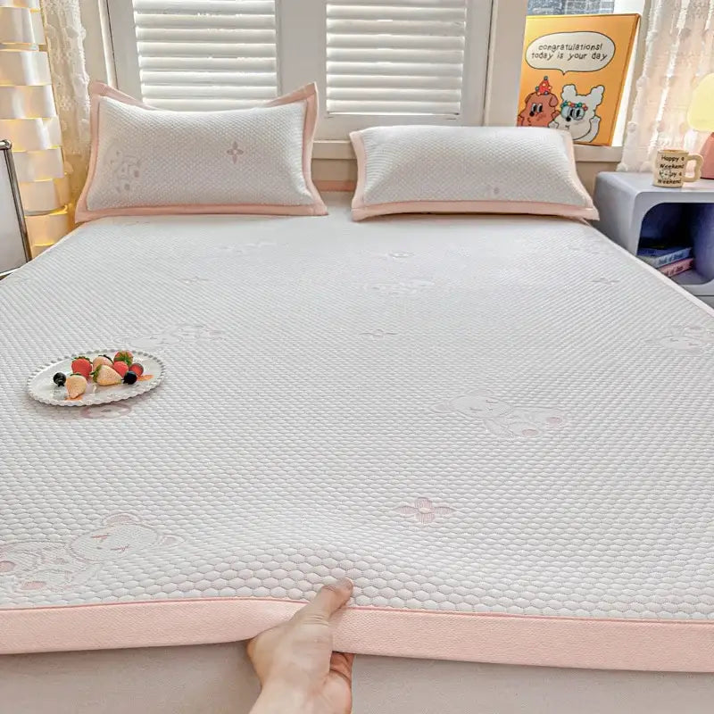 Soft white textured cooling feel mat set with subtle pink border and embroidered bear designs for bedroom mattress