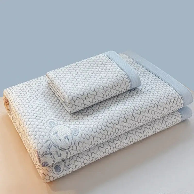 Light blue and white honeycomb cotton towel set with embroidered bear detail in cooling feel mat set for bedroom use
