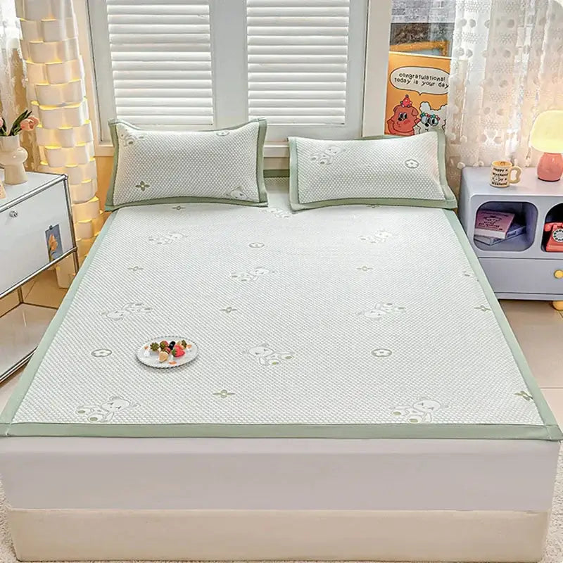 Light green and white patterned cooling feel mat set with embroidered bear designs for bedroom mattress use