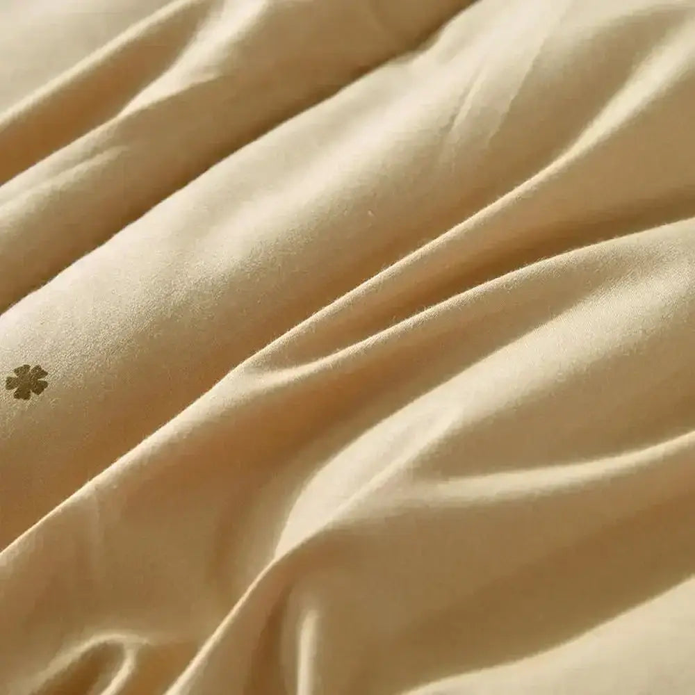 Embroidered beige camel hair quilted blanket featuring cream satin with gold four-leaf clover embroidery decorbites camel hair
