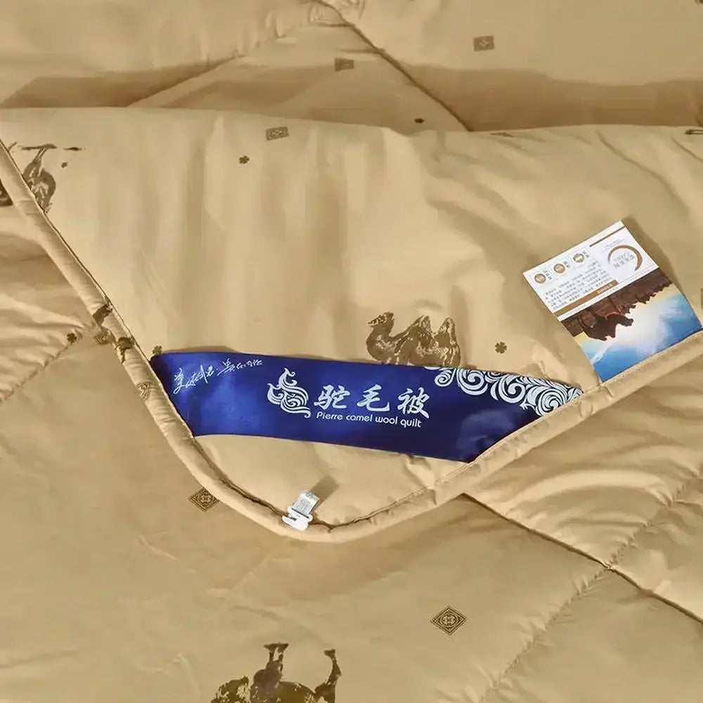 Beige camel hair quilted blanket with gold camel embroidery and blue pierre label for bedroom decorbites camel hair