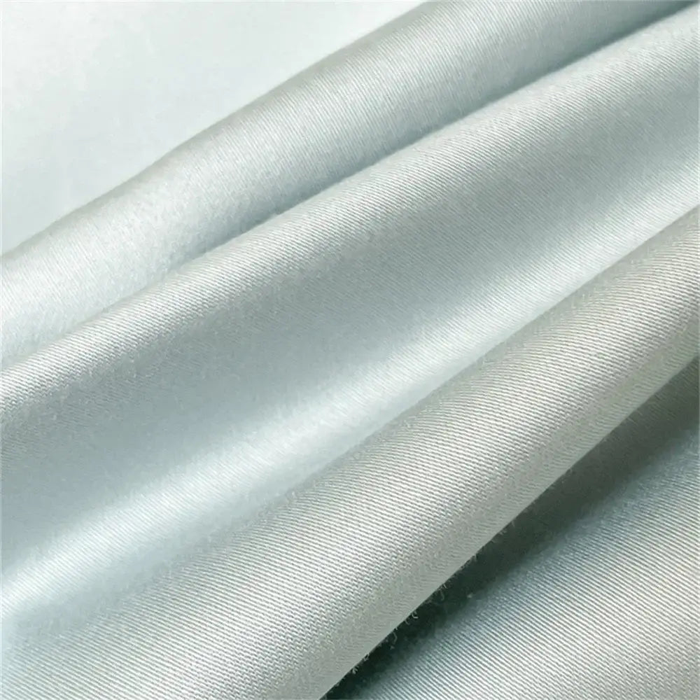 Light gray satin fabric with smooth glossy finish and subtle ribbing in embroidered blue butterfly duvet cover set