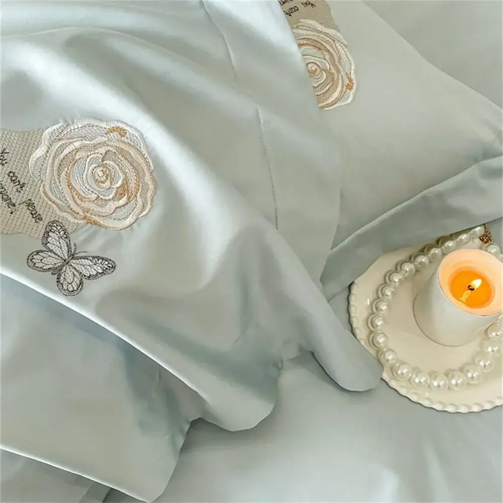 Light blue satin pillowcase with embroidered cream and silver roses and butterflies in egyptian cotton duvet cover set