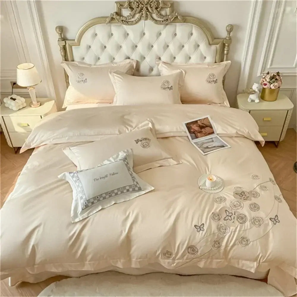 Cream-colored satin duvet cover set with delicate gray floral and blue butterfly embroidery in Egyptian cotton