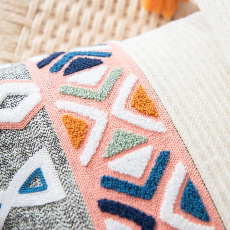 A cozy decorbites embroidered blue tufted pillow cover with vibrant peach navy white and olive geometric pattern for bedroom boho decor