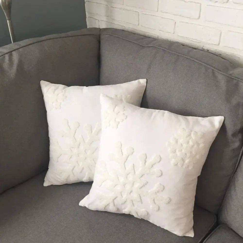 White square pillow covers with embroidered christmas snowflake designs for elegant living room decor by decorbites