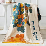 Cream-colored embroidered cotton gauze bath towels with vibrant orange and blue fruit motifs and traditional calligraphy decor