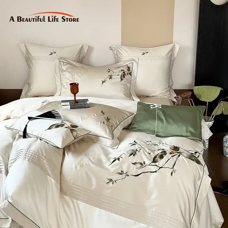 Cream-colored satin bedding set with black and gold floral embroidery made from lyocell cotton for decorbites deluxe lyocell luxury decor