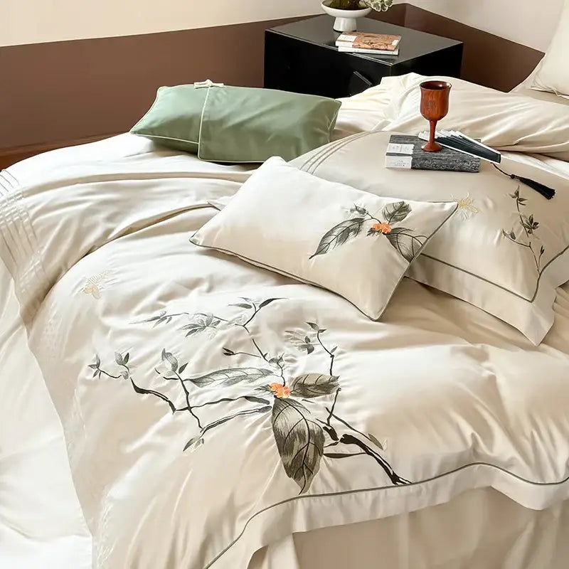 Cream-colored lyocell cotton bedding set with delicate black and orange floral embroidery for decorbites deluxe lyocell luxury decor