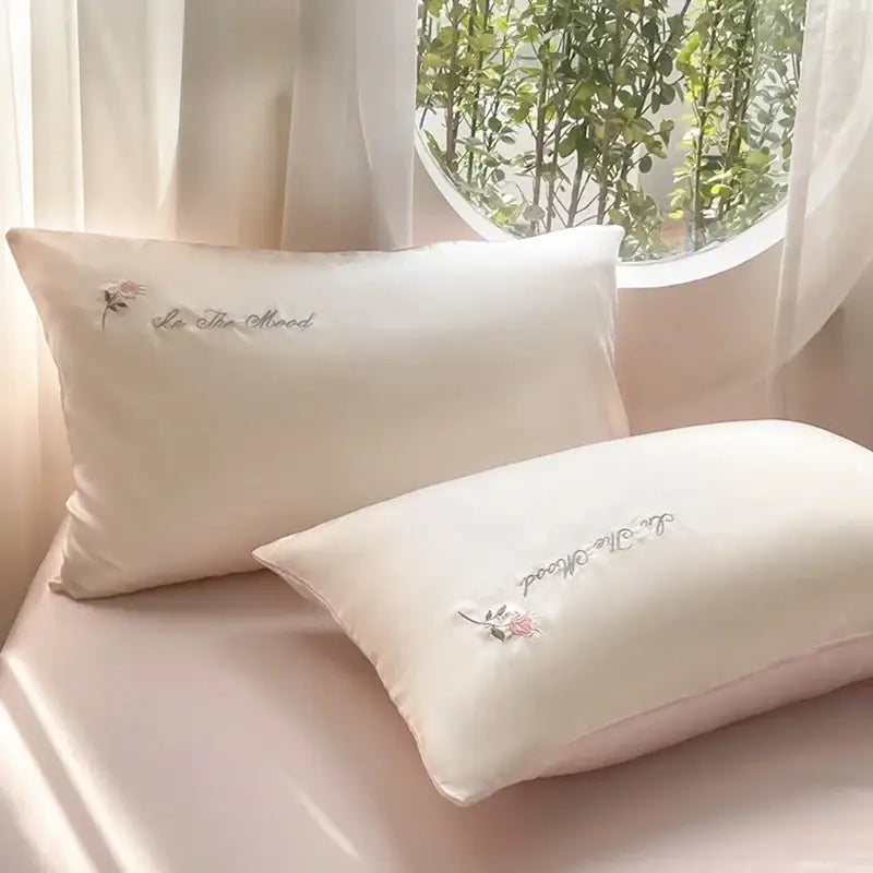 Cream satin ice silk bedding sets featuring delicate floral embroidery and lie the mood script for elegant bedroom decorbites ice silk