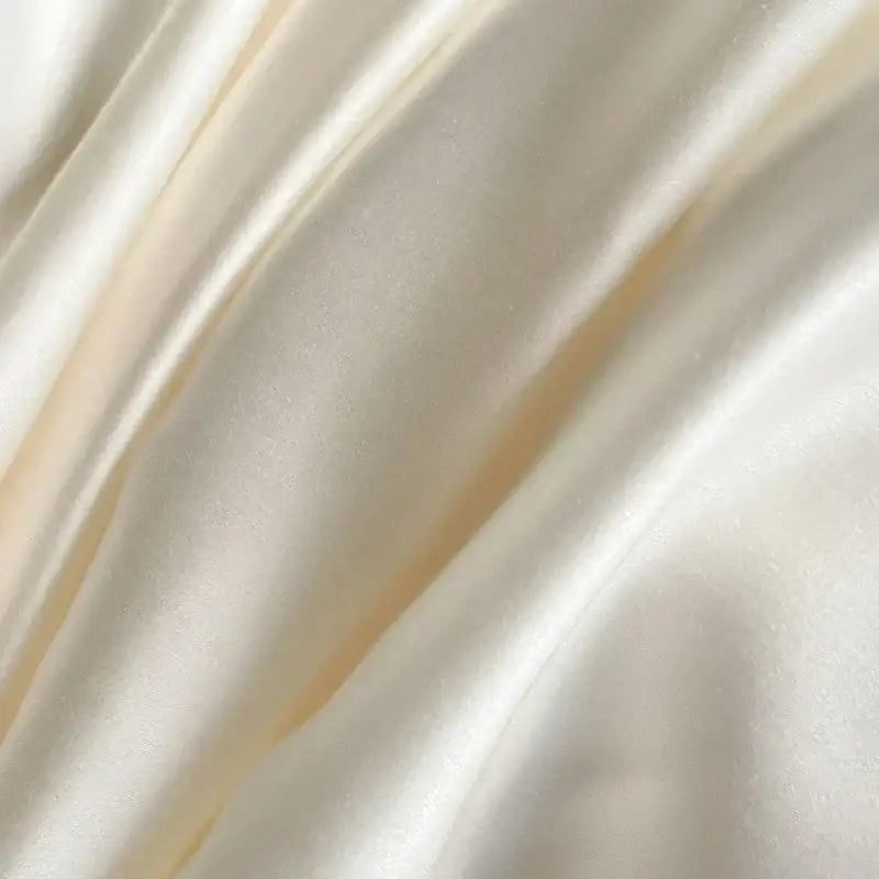 Cream satin ice silk bedding sets with smooth glossy texture and gentle folds for elegant bedroom decorbites ice silk
