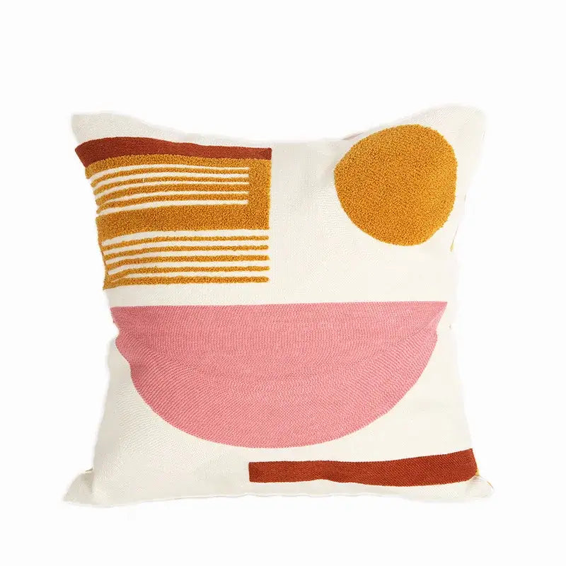Cream-colored embroidered cushion cover with textured geometric patterns in mustard yellow, dusty rose, and terracotta brown from a cushion cover set