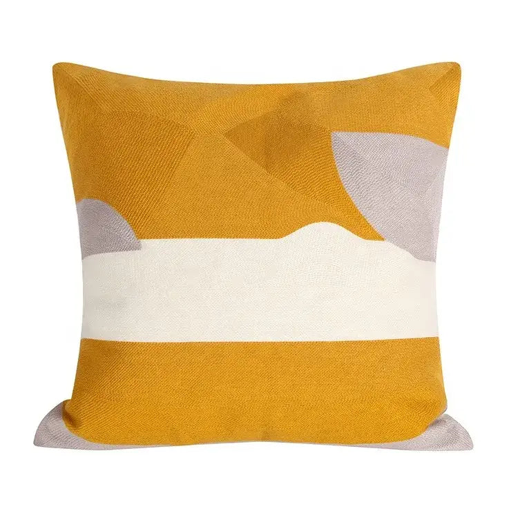 Square embroidered cushion cover with mustard yellow textured base and white geometric patterns in cushion cover set
