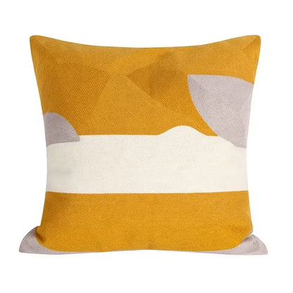 Square embroidered cushion cover with mustard yellow textured base and white geometric patterns in cushion cover set