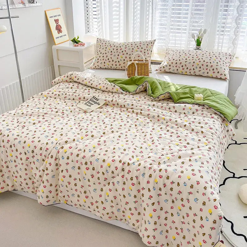 Cream-colored quilted comforter with playful multicolored bears and flowers made of double gauze rabbit print fabric
