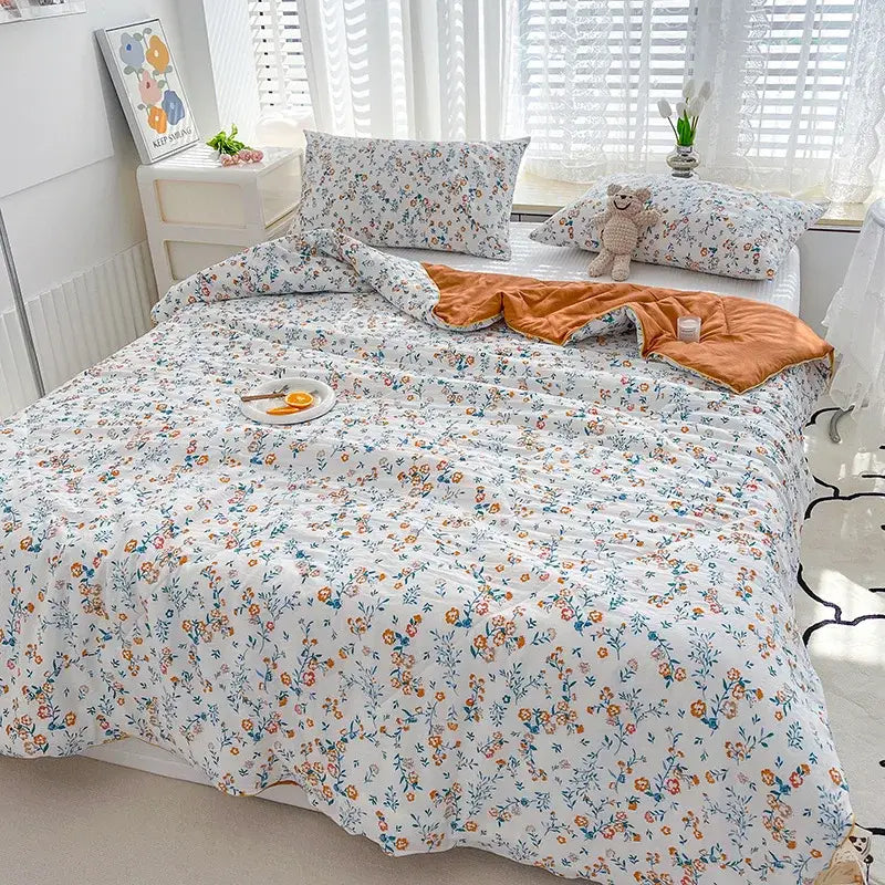 White floral patterned double gauze quilt with orange inner lining featuring embroidered double gauze rabbit print design