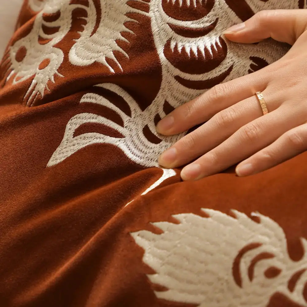 A rich brown velvet embroidered dragon year pillowcase with intricate white dragon motifs for rust and white living room decor