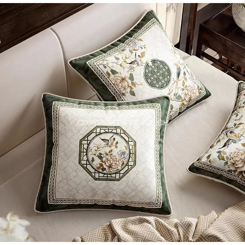 Square cushion covers with cream quilted center, dark green velvet frame, and embroidered dream floral birds design